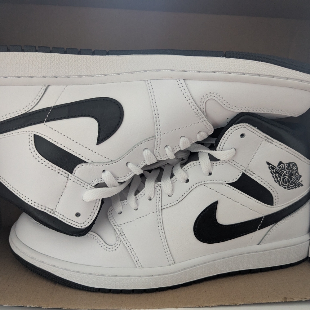 Air Jordan 1 Mid sneakers.  White leather upper, black accents.  Size 10US
